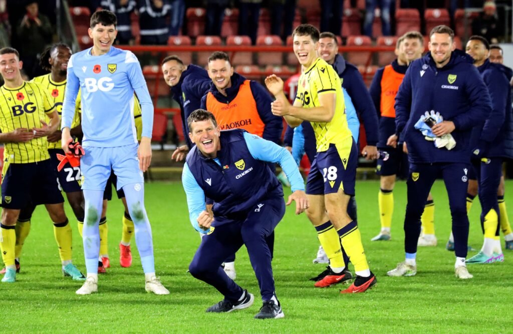 Caretaker manager Craig Short and the United players celebrate on United's last visit to Orient